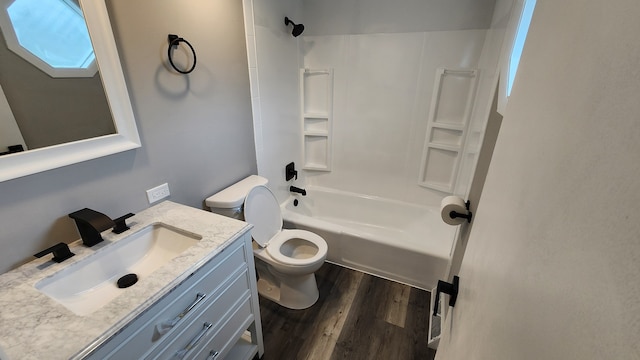 full bathroom featuring toilet, vanity, wood-type flooring, and shower / washtub combination