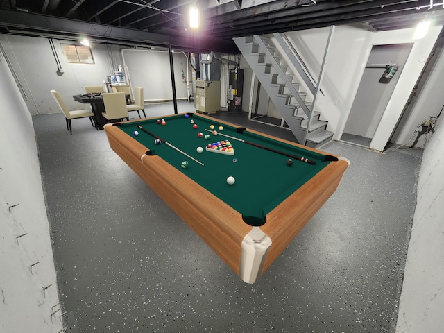 recreation room featuring water heater, heating unit, and pool table