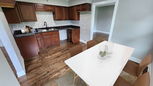 kitchen with dark hardwood / wood-style flooring, sink, and tasteful backsplash