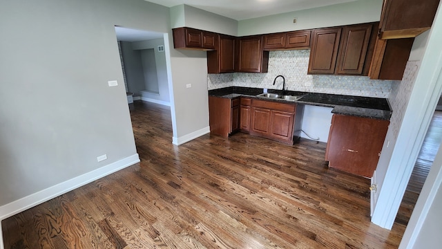 kitchen featuring tasteful backsplash, sink, and dark hardwood / wood-style floors