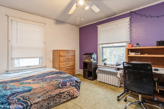 bedroom with ceiling fan, radiator heating unit, crown molding, and carpet