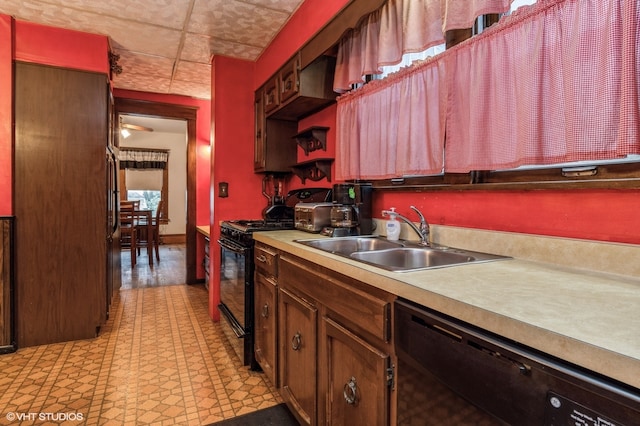 kitchen featuring black appliances, sink, and ceiling fan