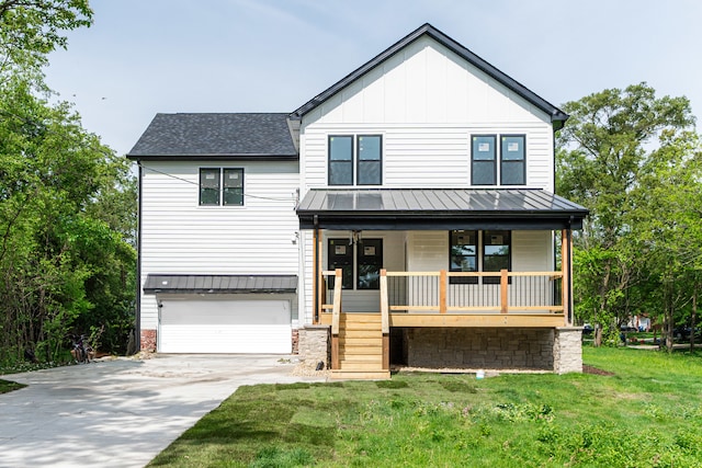 modern inspired farmhouse featuring driveway, a standing seam roof, a porch, an attached garage, and metal roof