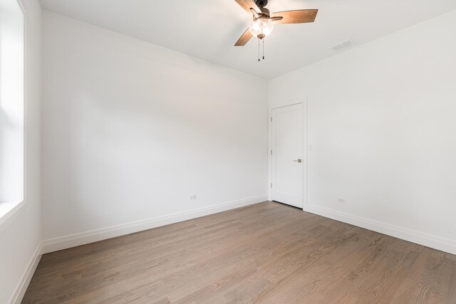 empty room with light hardwood / wood-style flooring and ceiling fan