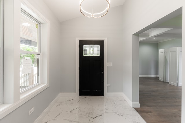 foyer entrance with lofted ceiling and hardwood / wood-style flooring