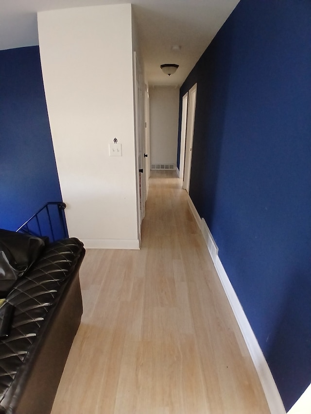 hallway with light hardwood / wood-style flooring