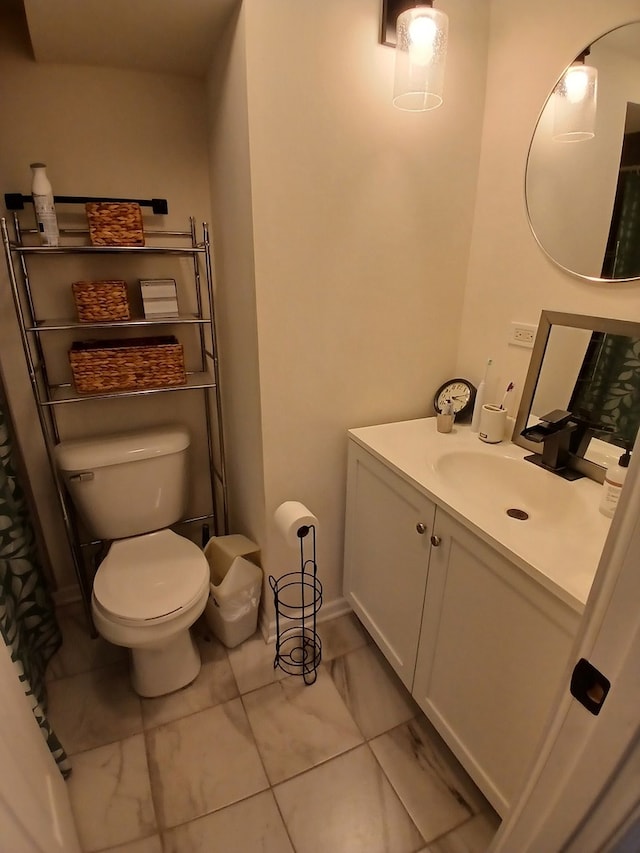 bathroom featuring toilet, vanity, and tile patterned flooring