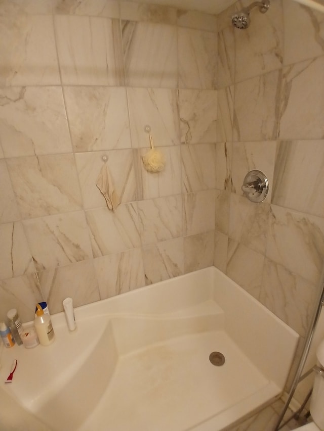 bathroom with tiled shower