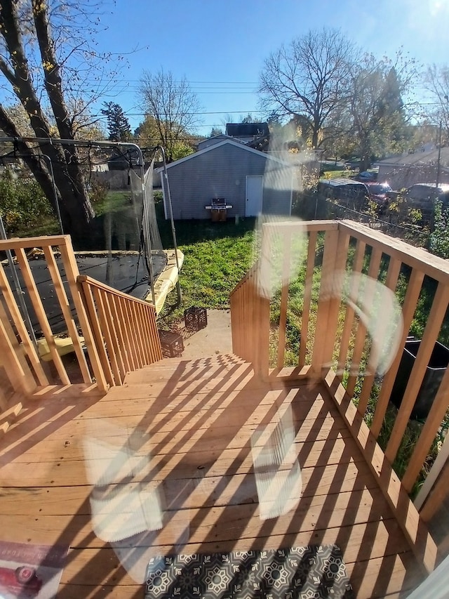 wooden deck featuring a trampoline