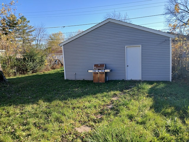 view of outbuilding with a lawn