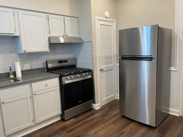 kitchen with stainless steel appliances, white cabinets, dark wood-type flooring, and backsplash