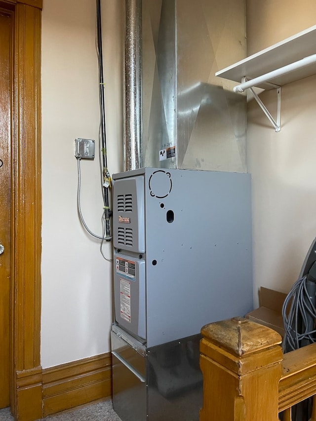 utility room featuring heating unit