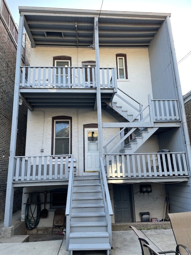 back of property with a balcony