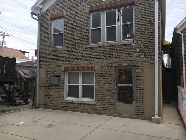 rear view of house with a patio area and a wooden deck