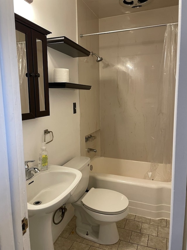 bathroom featuring tile patterned flooring, toilet, and shower / tub combo