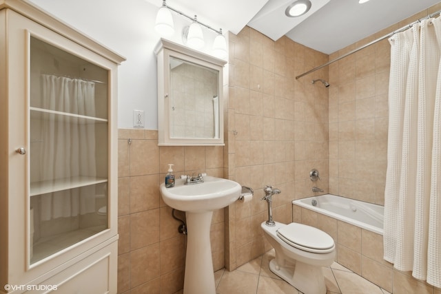 full bathroom with tile walls, sink, tile patterned flooring, toilet, and shower / bath combo with shower curtain