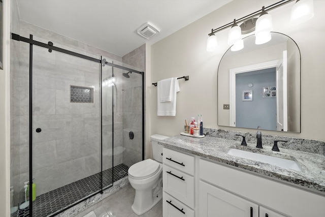 bathroom featuring tile patterned flooring, vanity, toilet, and an enclosed shower