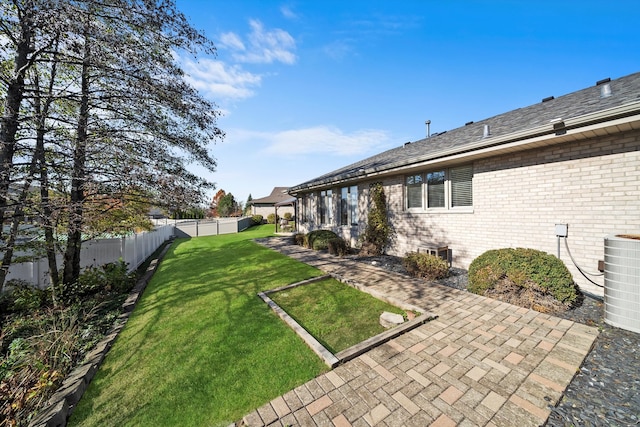 view of yard with a patio and central AC