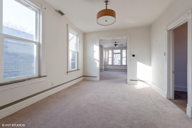 spare room featuring crown molding, light colored carpet, and a baseboard radiator