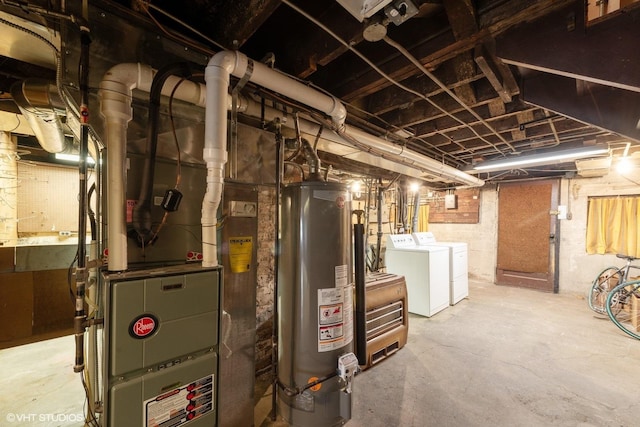 basement with gas water heater and washer and clothes dryer