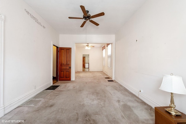 unfurnished living room featuring ceiling fan and light colored carpet