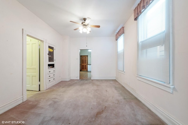 unfurnished bedroom featuring light carpet and ceiling fan