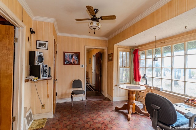 home office with ceiling fan, wooden walls, and ornamental molding