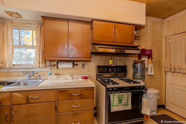 kitchen featuring black gas range oven, sink, light tile patterned floors, and ornamental molding