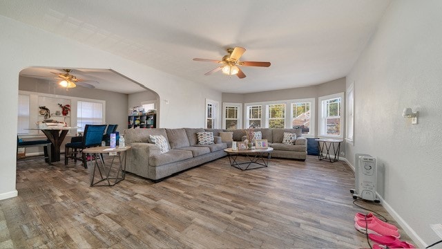 living room with wood-type flooring and ceiling fan