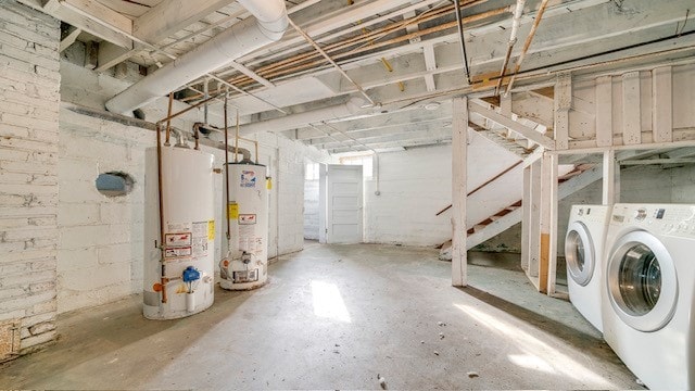 basement featuring water heater and independent washer and dryer