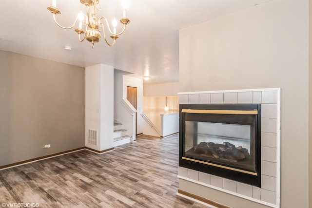 unfurnished living room with hardwood / wood-style floors and a multi sided fireplace