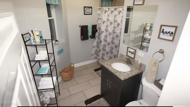 bathroom featuring walk in shower, tile patterned flooring, vanity, and toilet