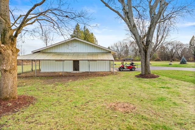 view of property exterior featuring a yard and an outdoor structure