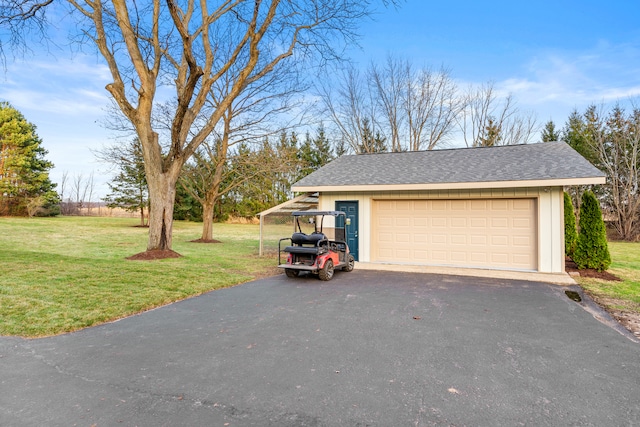 garage featuring a lawn