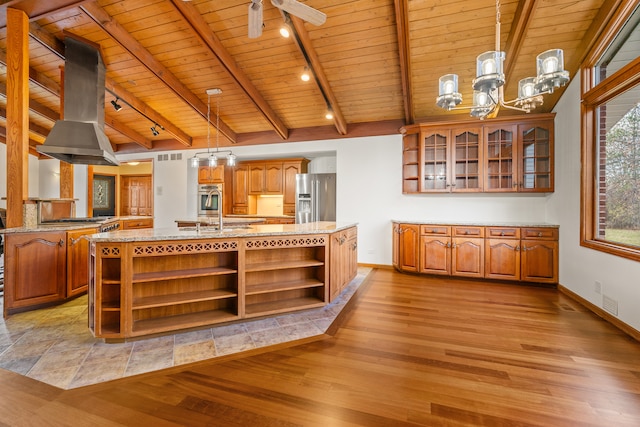 kitchen featuring a center island with sink, light hardwood / wood-style floors, and appliances with stainless steel finishes