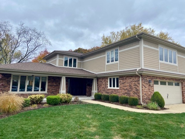 front facade with a front yard and a garage