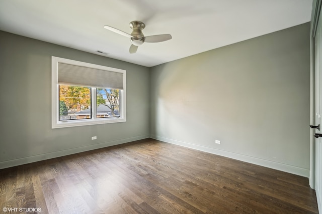 unfurnished room featuring ceiling fan and dark wood-type flooring