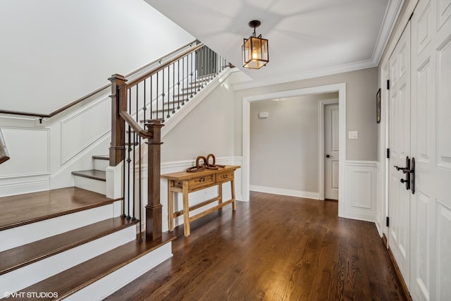 entrance foyer with dark hardwood / wood-style flooring and ornamental molding