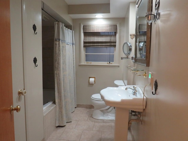 bathroom featuring tile patterned floors, shower / bath combo, and toilet