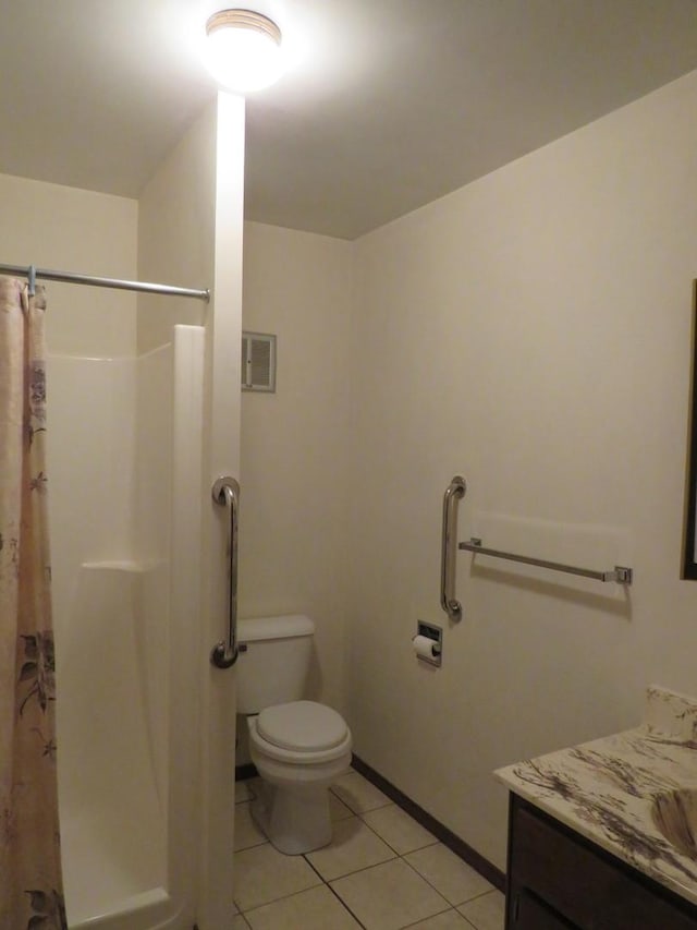 bathroom with toilet, tile patterned flooring, vanity, and walk in shower