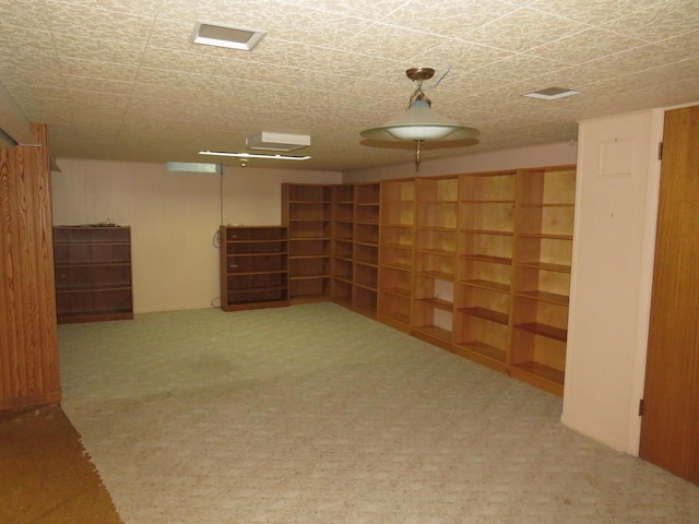 basement featuring carpet floors and a textured ceiling