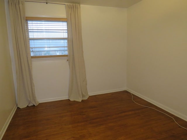 empty room with dark hardwood / wood-style floors