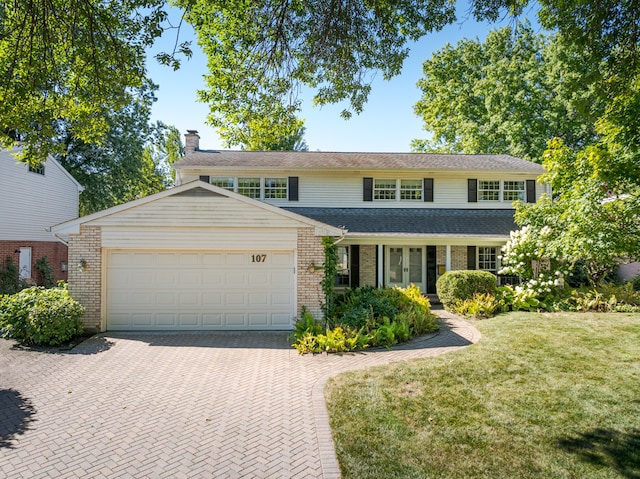 front of property with a front yard and a garage