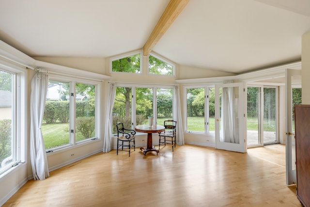 sunroom / solarium with plenty of natural light and vaulted ceiling with beams