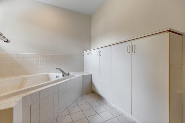 bathroom featuring tiled tub and tile patterned floors