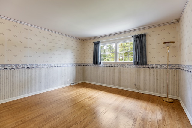 spare room featuring wood-type flooring