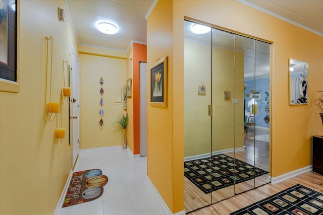 hall with ornamental molding and light wood-type flooring