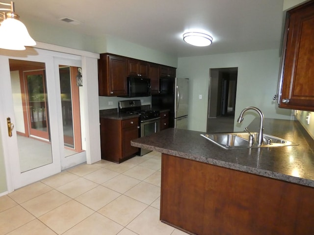 kitchen with kitchen peninsula, black appliances, sink, and light tile patterned floors