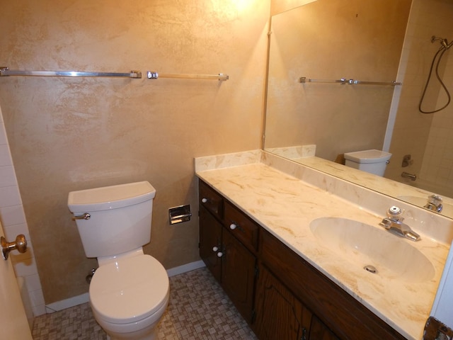 bathroom featuring toilet, vanity, and tile patterned floors