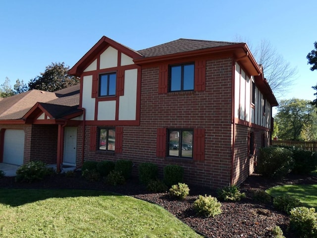 view of front of property with a front yard and a garage